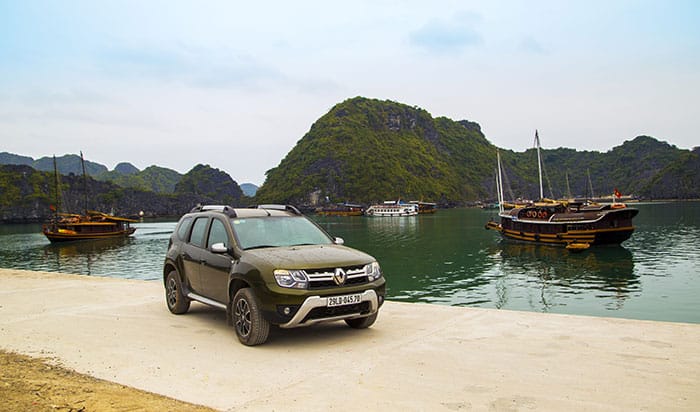 A car with Halong Bay in the background